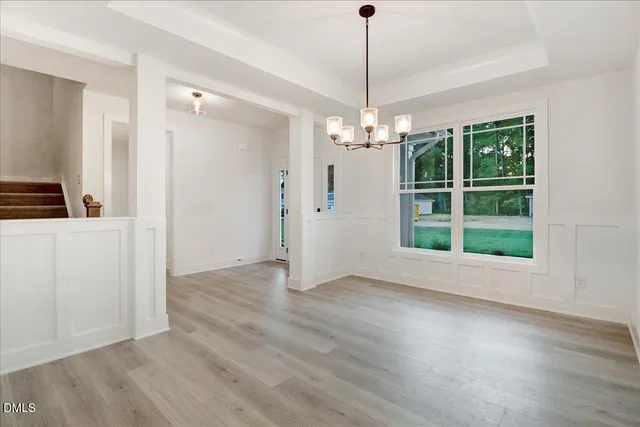 an empty room with windows fireplace and a sink