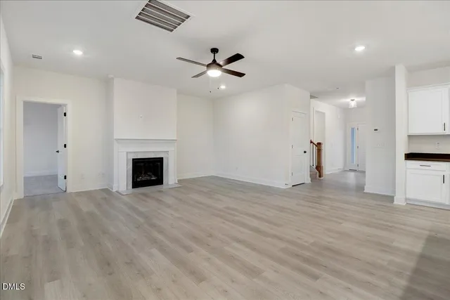 a view of kitchen with kitchen island wooden floors and stainless steel appliances