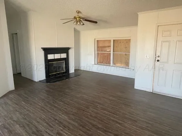 a view of a living room with hardwood floor and a window