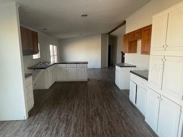 a view of a room with wooden floor and a window