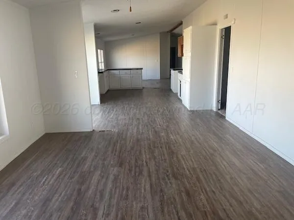 a view of a kitchen with wooden floor and staircase