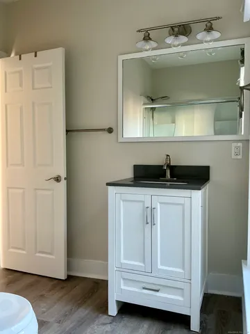 a bathroom with a sink vanity and mirror