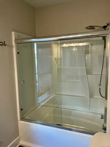 a bathroom with a shower and a tub