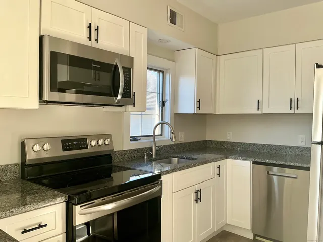 a kitchen with a stove and microwave