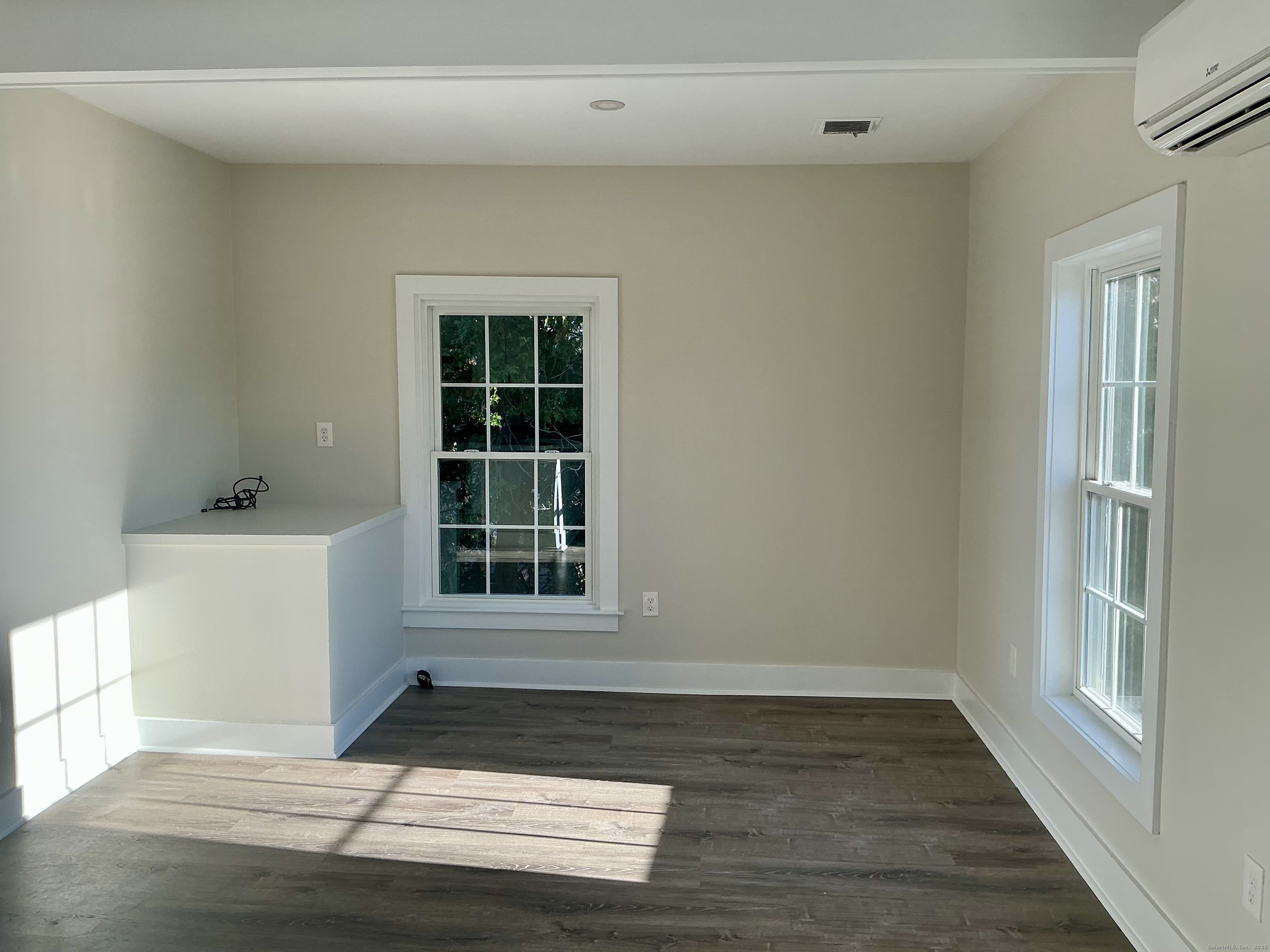 17 Willow Street, Unit 2 Mystic, CT 06355 - Photo 9 of 20 a view of an empty room with wooden floor and a window