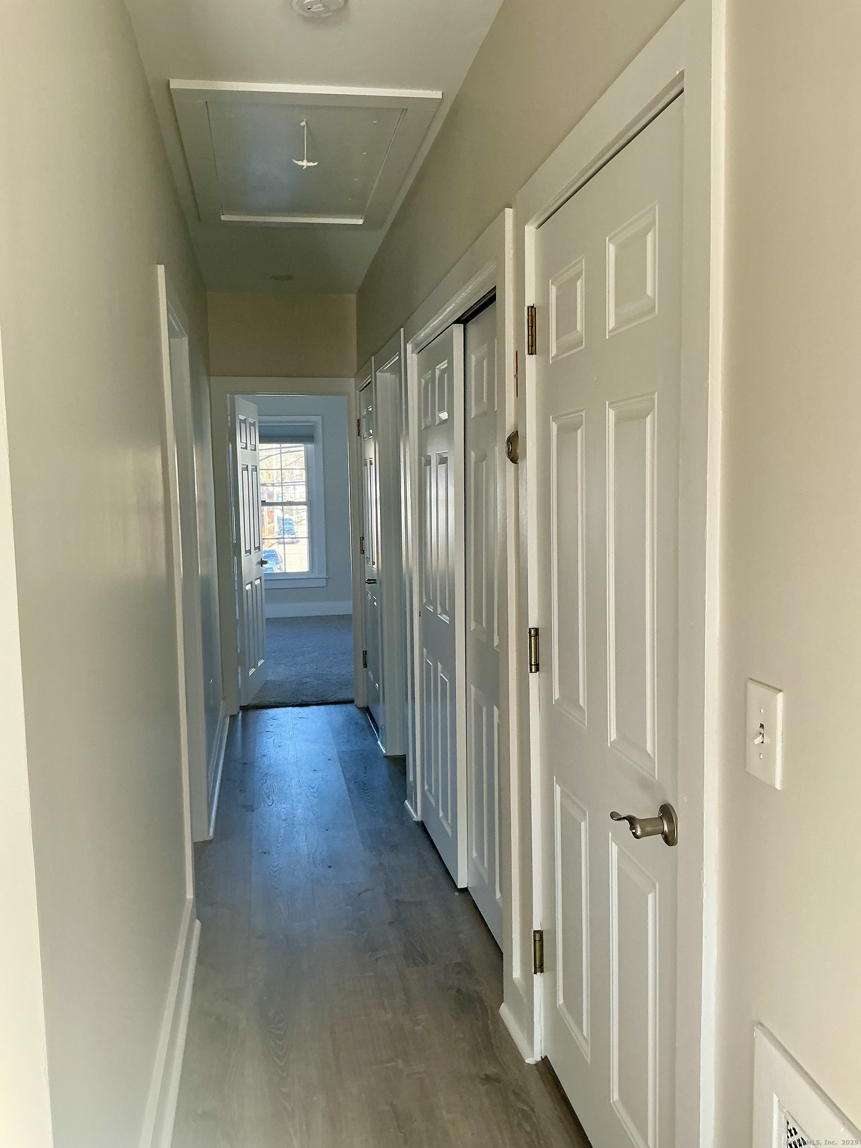 17 Willow Street, Unit 2 Mystic, CT 06355 - Photo 10 of 20 a view of a hallway with wooden floor and closet area