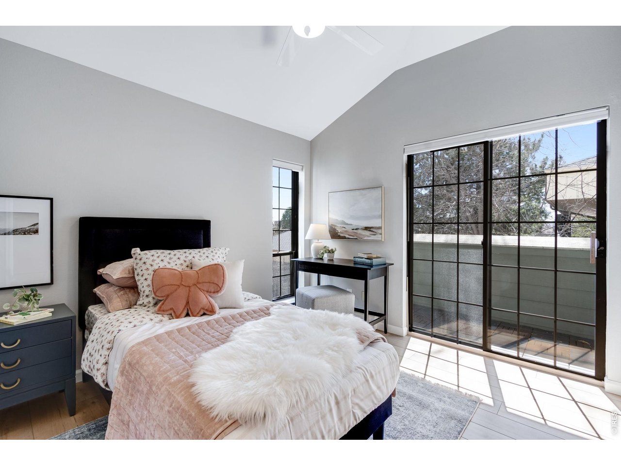 3473 28th Street, Unit 12 Boulder, CO 80301 - Photo 11 of 39 a bedroom with a bed and glass door