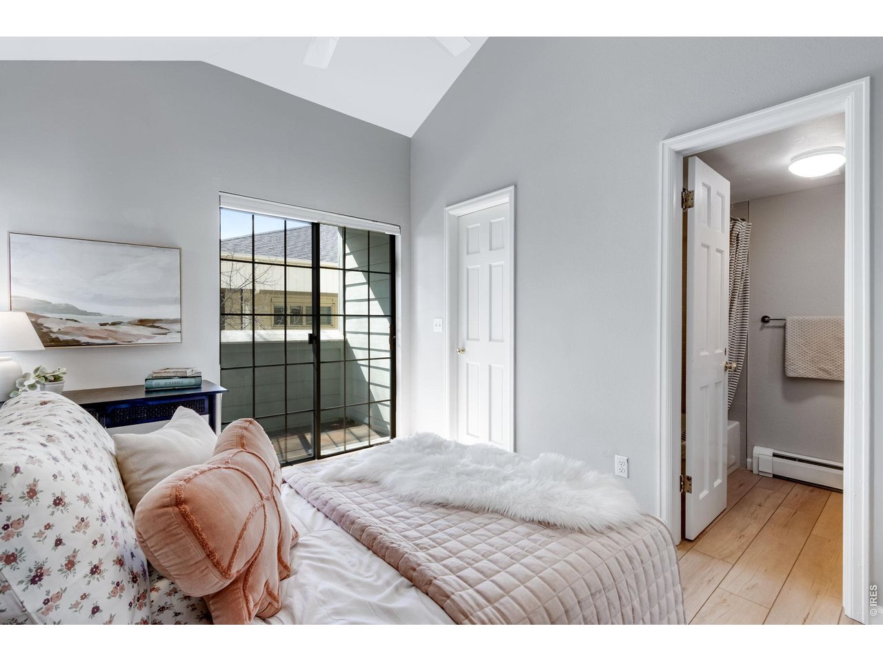3473 28th Street, Unit 12 Boulder, CO 80301 - Photo 12 of 39 a bedroom with a bed and a large window