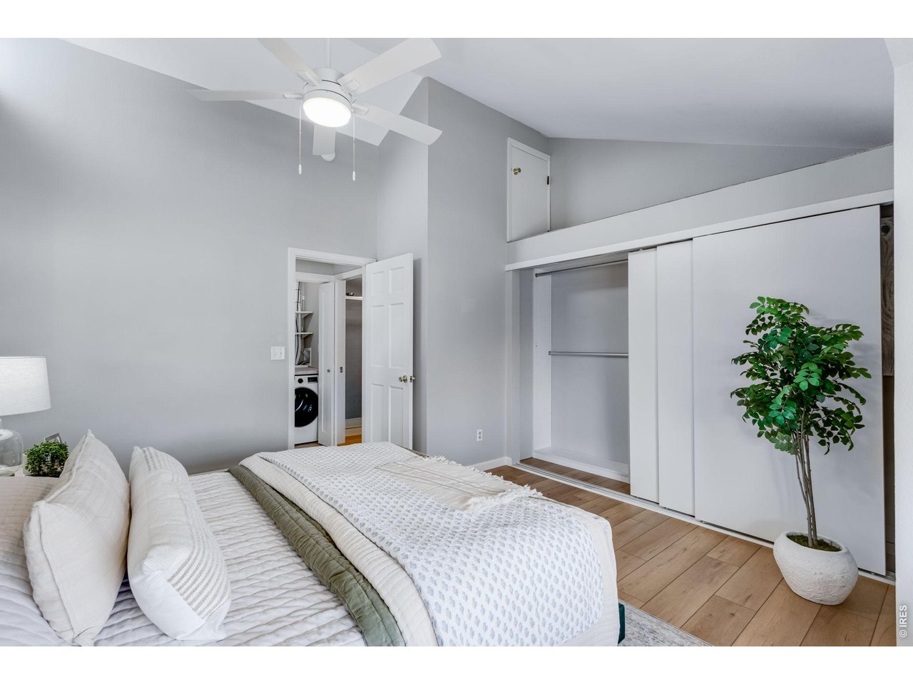 3473 28th Street, Unit 12 Boulder, CO 80301 - Photo 18 of 39 a bedroom with a bed and a potted plant