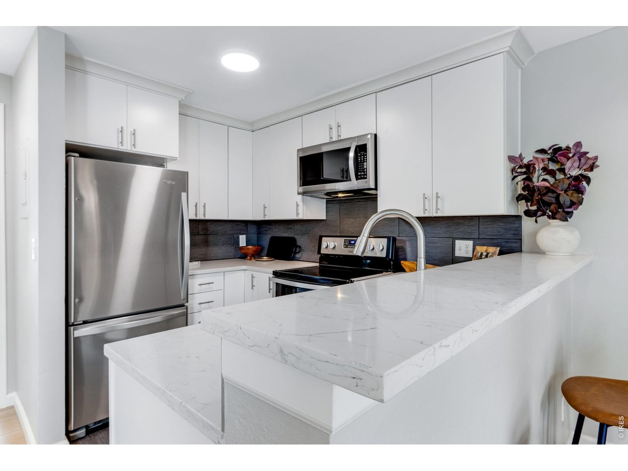 3473 28th Street, Unit 12 Boulder, CO 80301 - Photo 21 of 39 a kitchen with stainless steel appliances a refrigerator sink and microwave