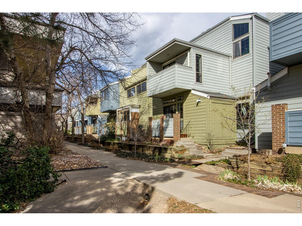 3473 28th Street, Unit 12 Boulder, CO 80301 - Photo 36 of 39 a view of a white house with large windows