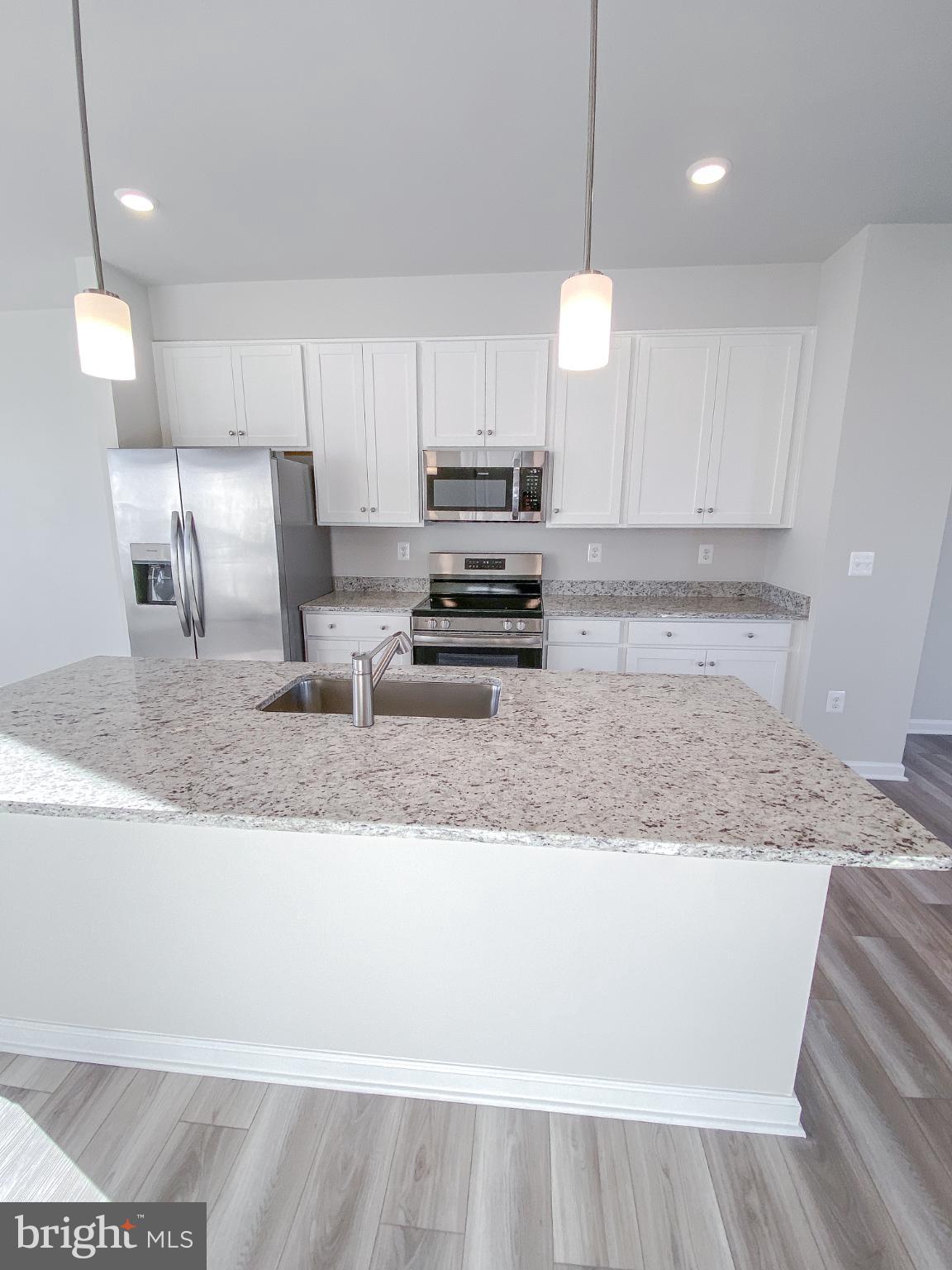 141 Canning Road Inwood, WV 25428 - Photo 11 of 29 a kitchen with kitchen island a counter top space a sink and appliances