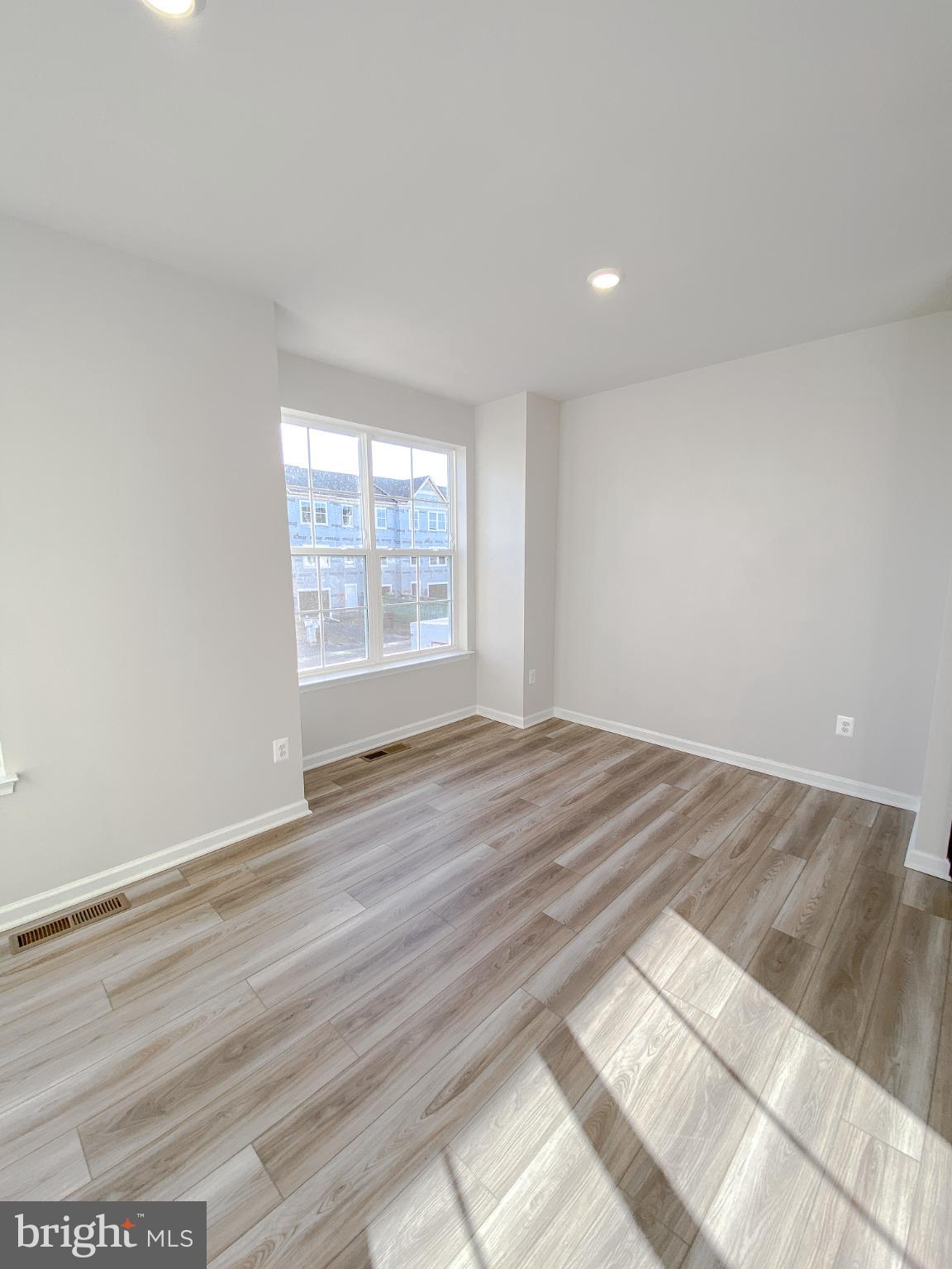 141 Canning Road Inwood, WV 25428 - Photo 13 of 29 an empty room with wooden floor and windows
