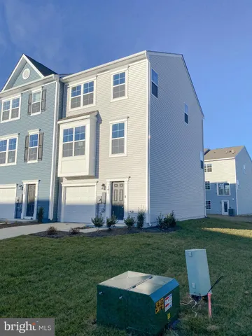 a front view of a house with a yard table and chairs