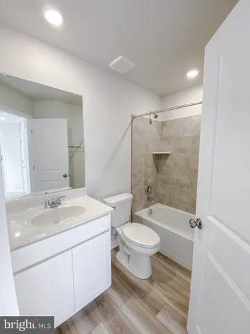 a bathroom with a toilet and a bathtub