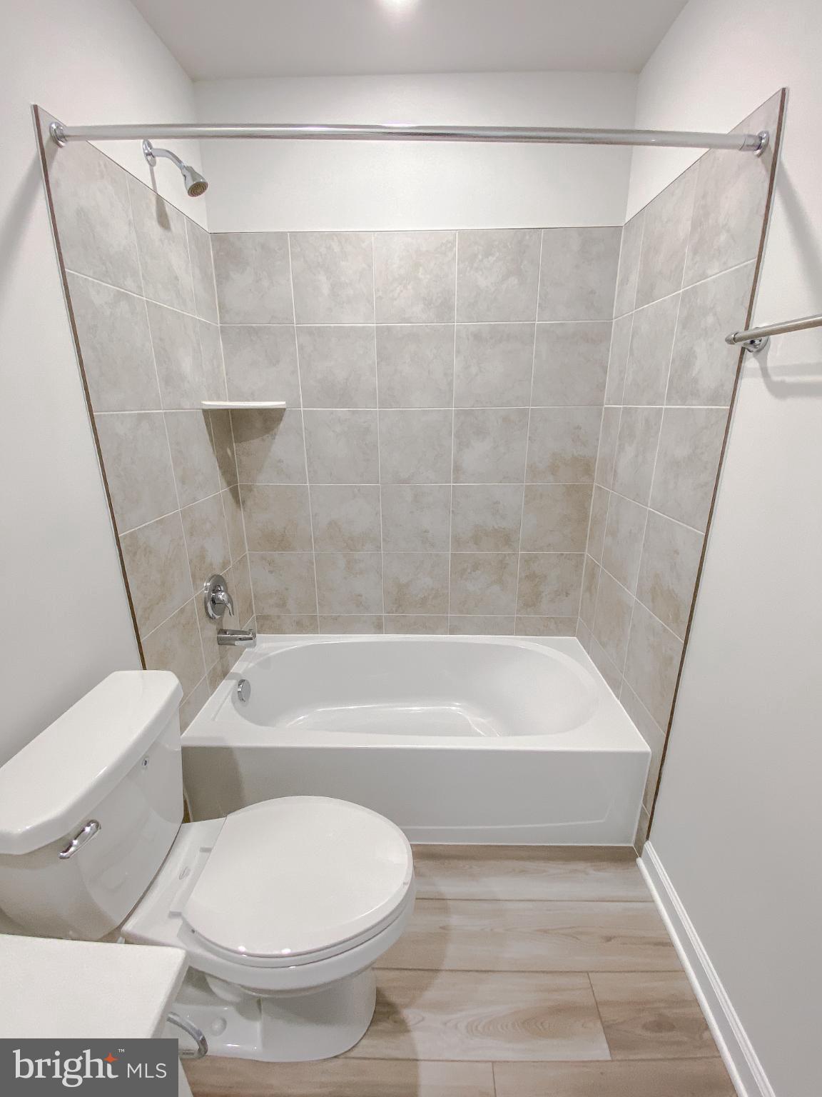 141 Canning Road Inwood, WV 25428 - Photo 22 of 29 a bathroom with a toilet and a bathtub