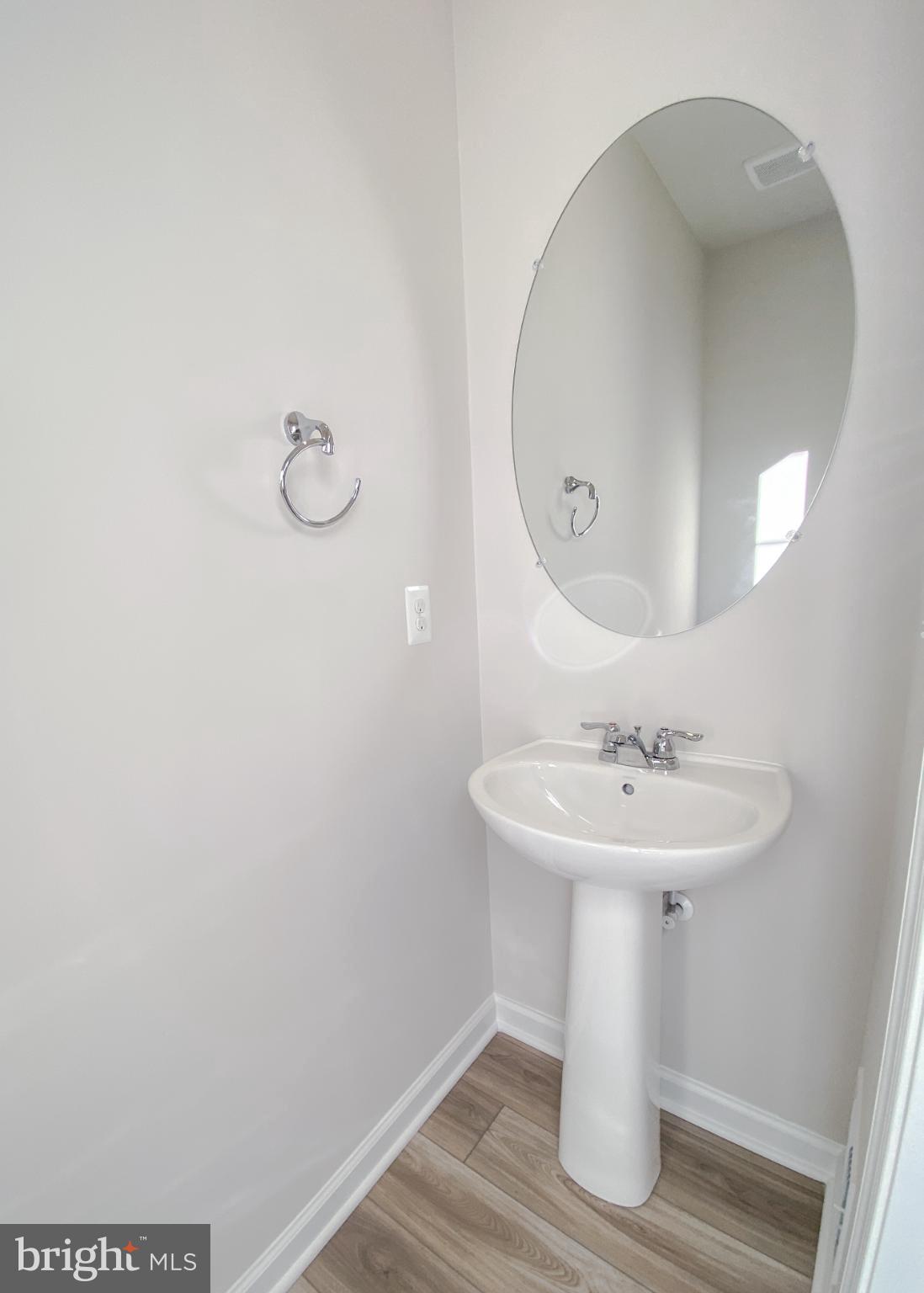 141 Canning Road Inwood, WV 25428 - Photo 9 of 29 a bathroom with a sink a mirror and vanity