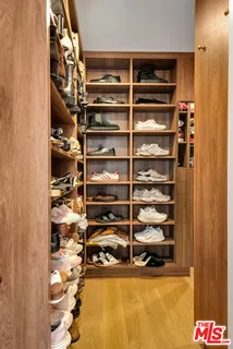 a view of walk in closet with empty racks