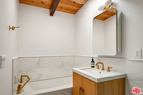a bathroom with a sink and mirror