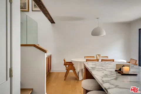a bedroom with a table and chairs