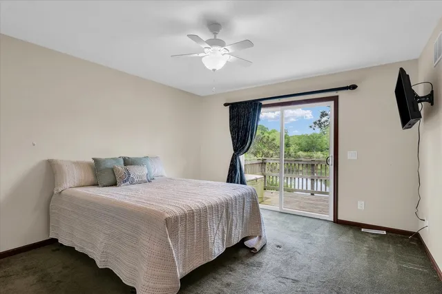 a view of a balcony with wooden floor and fence
