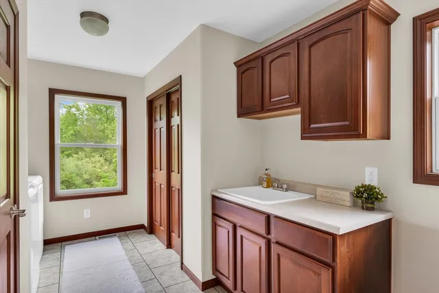 a view of empty room with wooden floor and ceiling fan