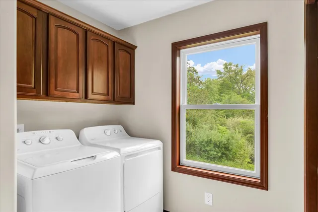 an empty room with windows and cabinet
