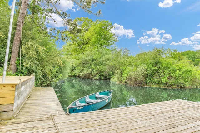 a view of a house with backyard sitting area and garden