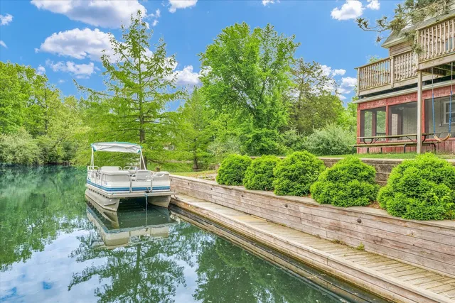 a view of a backyard with table and chairs and potted plants