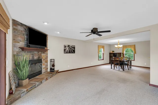 a kitchen with stainless steel appliances kitchen island granite countertop a refrigerator and a wooden cabinets