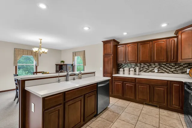 a kitchen with stainless steel appliances a refrigerator and a stove