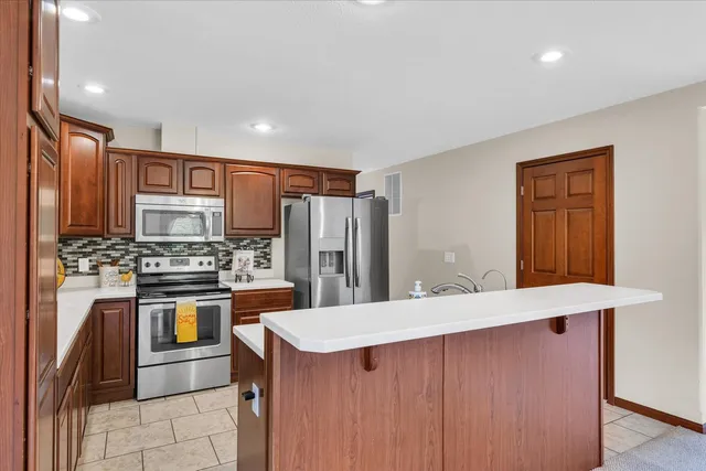 a kitchen with stainless steel appliances a refrigerator and a sink