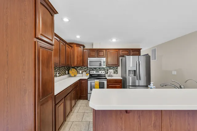 a kitchen with refrigerator and cabinets