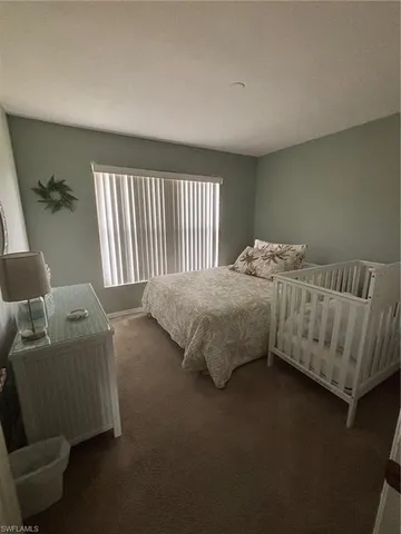 a bedroom with bed and a couch