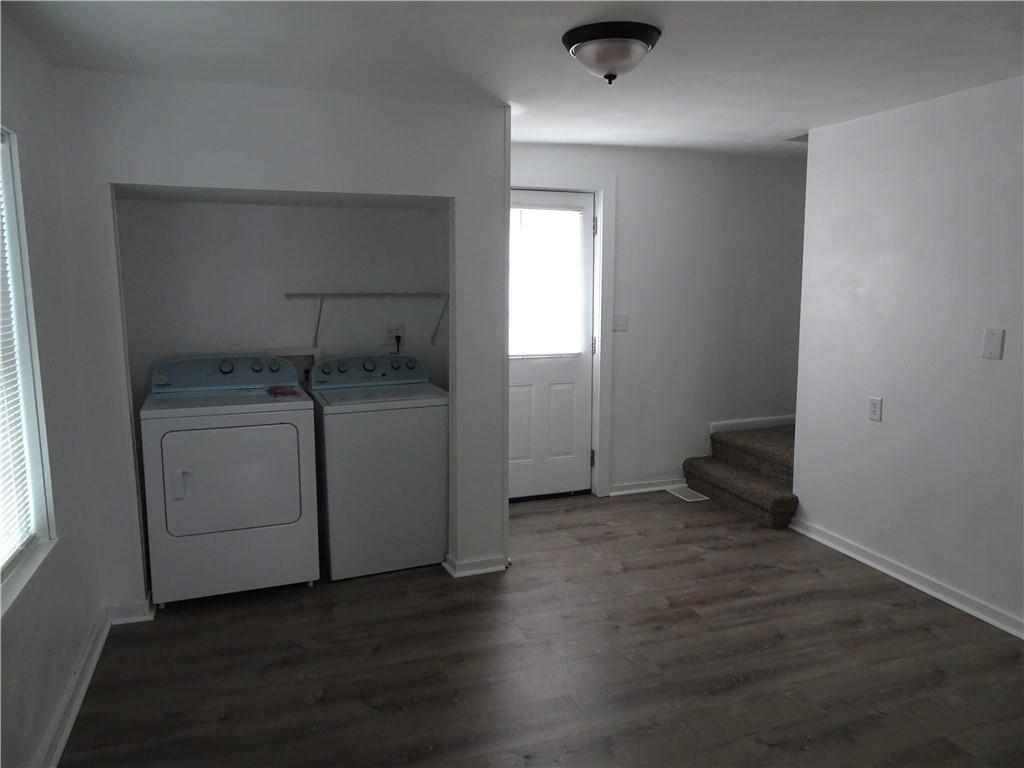 42 Oak Street Manor, PA 15665 - Photo 18 of 39 an empty room with wooden floor washer and dryer