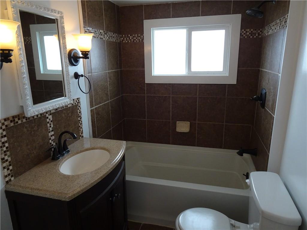 42 Oak Street Manor, PA 15665 - Photo 35 of 39 a bathroom with a granite countertop sink toilet and shower