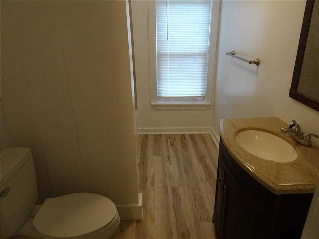 42 Oak Street Manor, PA 15665 - Photo 37 of 39 a bathroom with a granite countertop sink toilet and a mirror