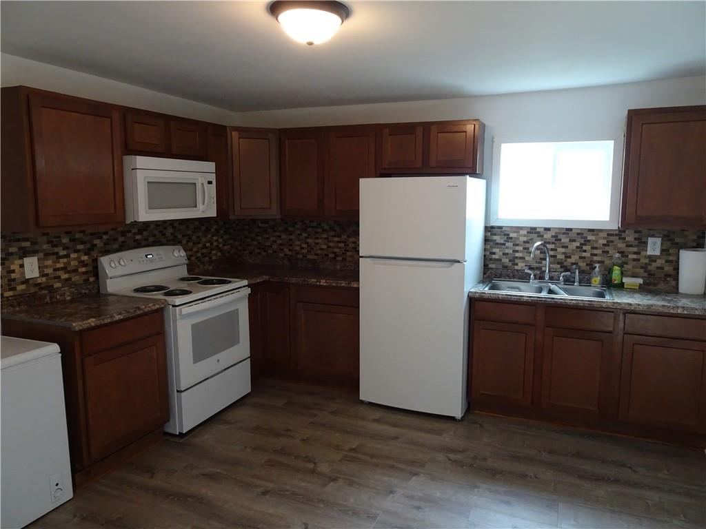 42 Oak Street Manor, PA 15665 - Photo 6 of 39 a kitchen with a refrigerator stove and sink