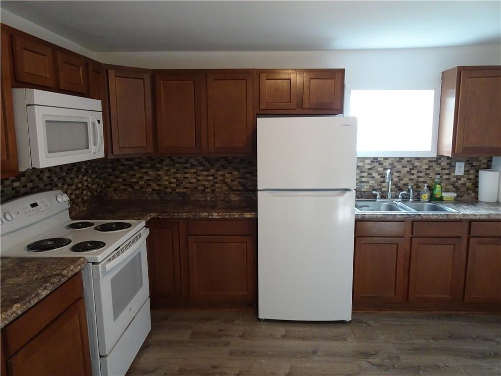 42 Oak Street Manor, PA 15665 - Photo 7 of 39 a kitchen with a refrigerator stove and microwave