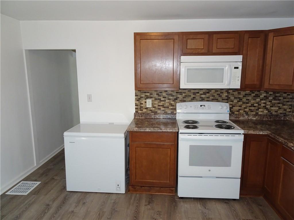42 Oak Street Manor, PA 15665 - Photo 8 of 39 a kitchen with a stove top oven and cabinets