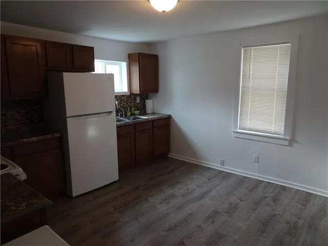 a kitchen with a refrigerator cabinet and a sink