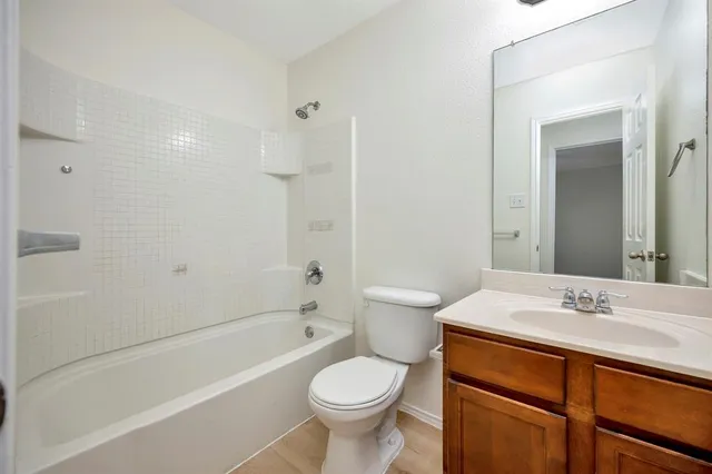 a bathroom with a sink toilet vanity and shower