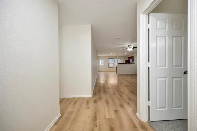 a view of hallway with wooden floor