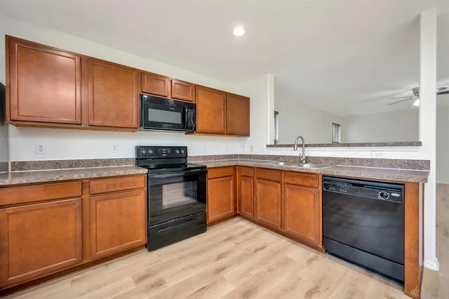 a kitchen with granite countertop stainless steel appliances and cabinets