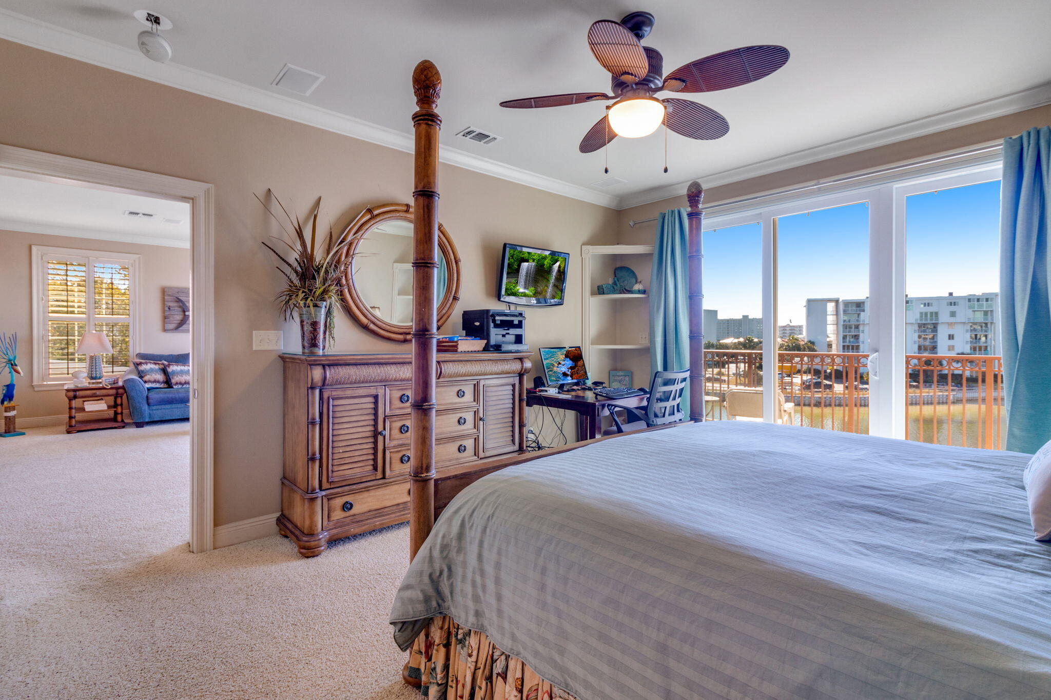 724 Harbor Boulevard, Unit 201 Destin, FL 32541 - Photo 12 of 25 a large bedroom with a bed a chandelier and a large window