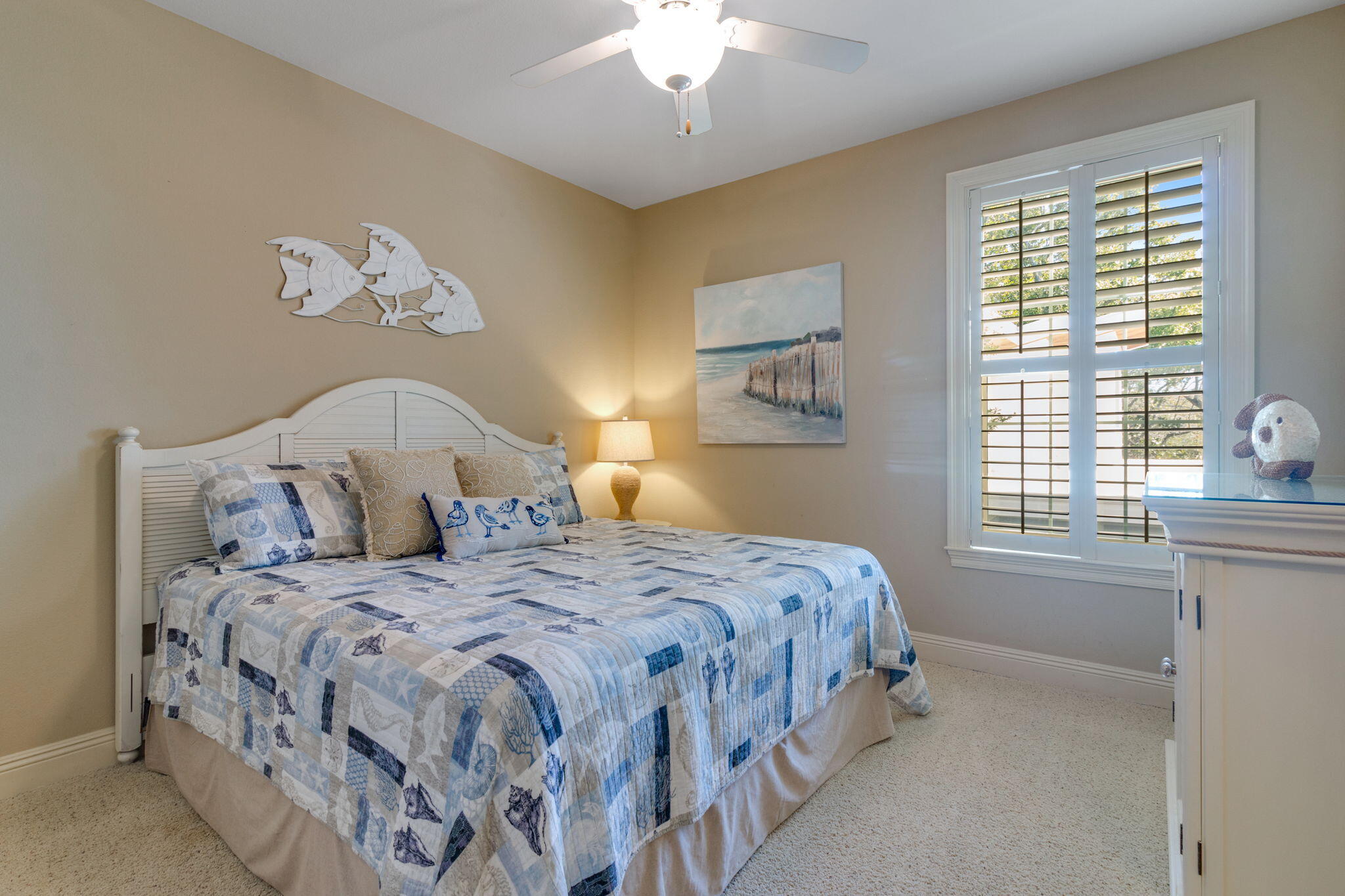 724 Harbor Boulevard, Unit 201 Destin, FL 32541 - Photo 16 of 25 a bedroom with a bed and a chandelier