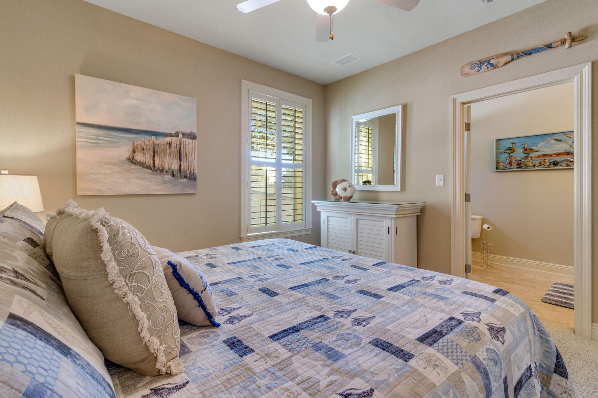 724 Harbor Boulevard, Unit 201 Destin, FL 32541 - Photo 17 of 25 a bedroom with a bed and a window