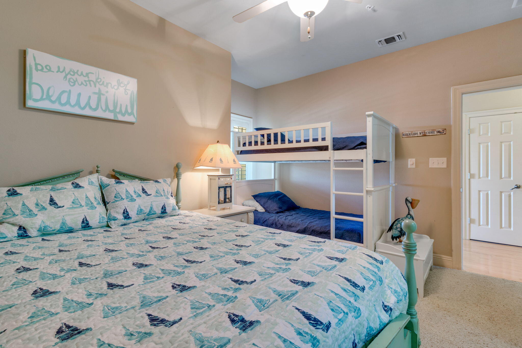 724 Harbor Boulevard, Unit 201 Destin, FL 32541 - Photo 20 of 25 a bedroom with a bed and a cabinets