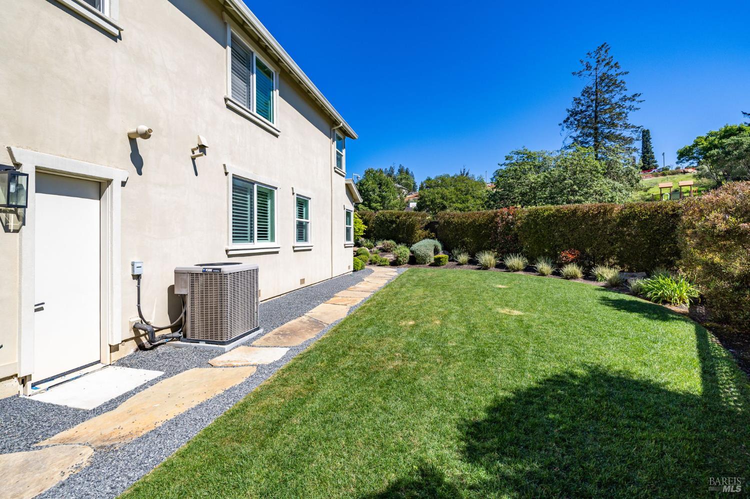 3726 Cannes Place Santa Rosa, CA 95403 - Photo 33 of 69 Here is a look at the south side of this home that offers a level area with grass and on automatic sprinklers for easy care. This view as seen from the gate as you would enter from the driveway.