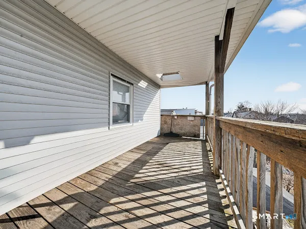 a view of a balcony with wooden floor